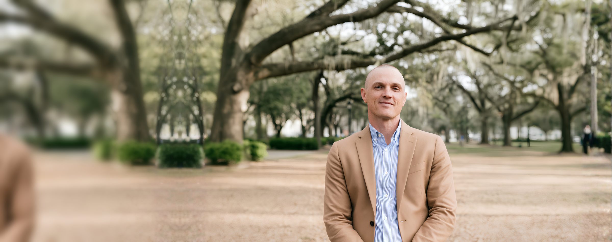 Justin Wilford standing beneath live oaks in Savannah